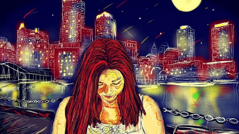 Na obrázku je červenovlasá žena v noci, stojící u řeky se sklopenou hlavou. Za řekou září město.
